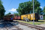 A former Toronto Streetcar stands next to a badly faded MILW Boxcar